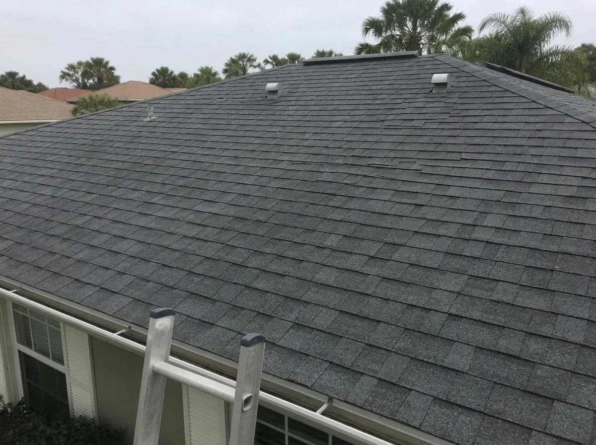 The same shingle roof restored to clean charcoal grey after soft washing